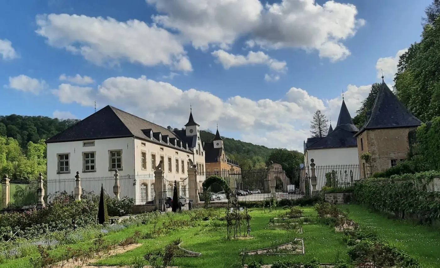 Approach to Ansembourg Castle showing its setting in Ansembourg, Luxembourg