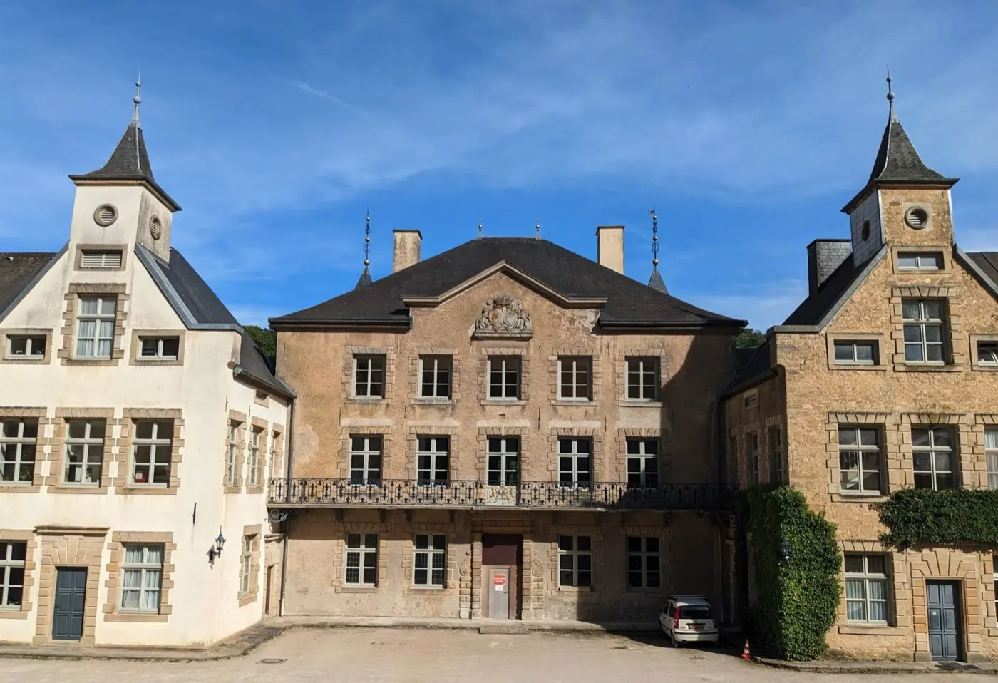 Stonework and visitor view of Ansembourg Castle, a grand castle in Ansembourg, Luxembourg