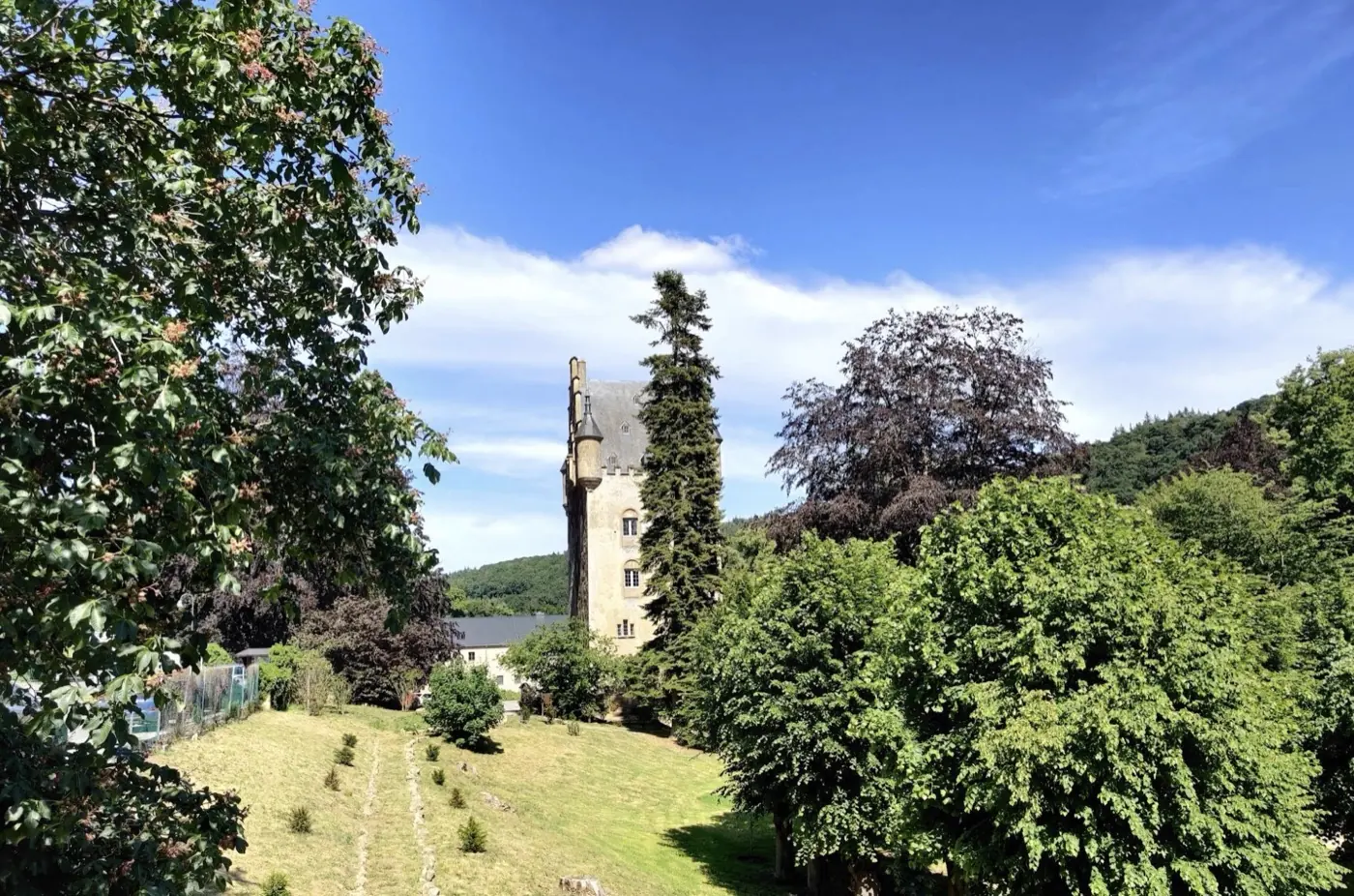 Approach to Schoenfels castle showing its setting in Mersch, Luxembourg